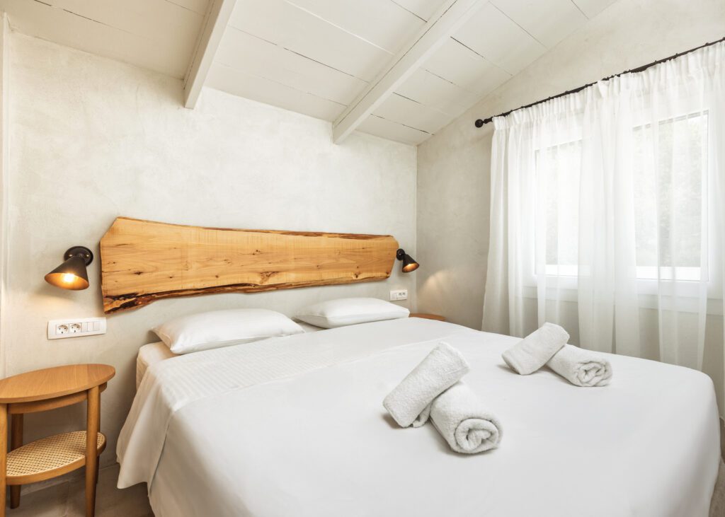 Elegant bedroom at Ilyessa Cottages in Zakynthos with a cozy queen-size bed and natural light.